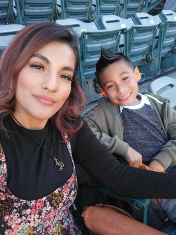 Patty and her son Mark sitting in a stadium