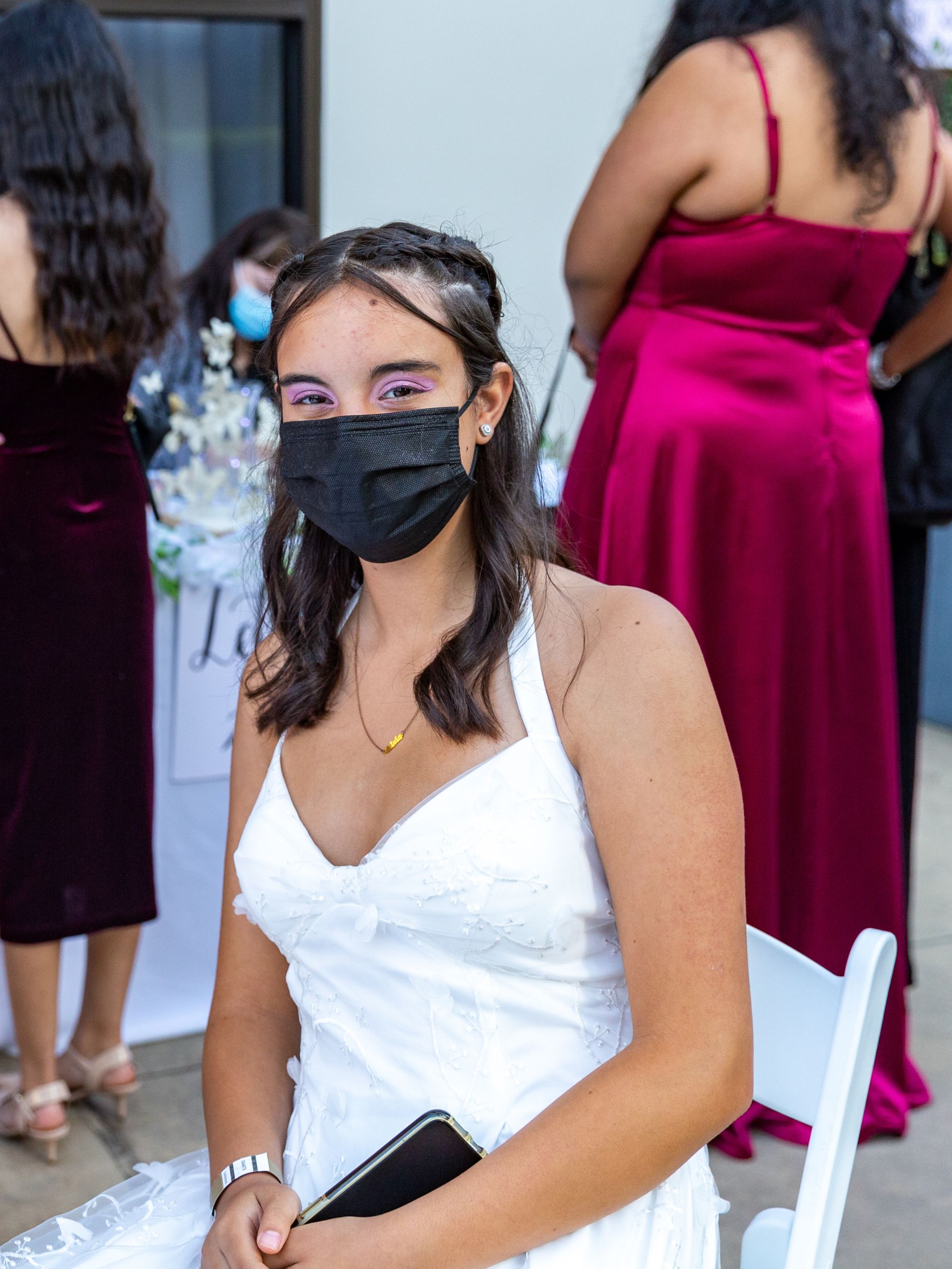 A brunette girl in a white dress at the ball