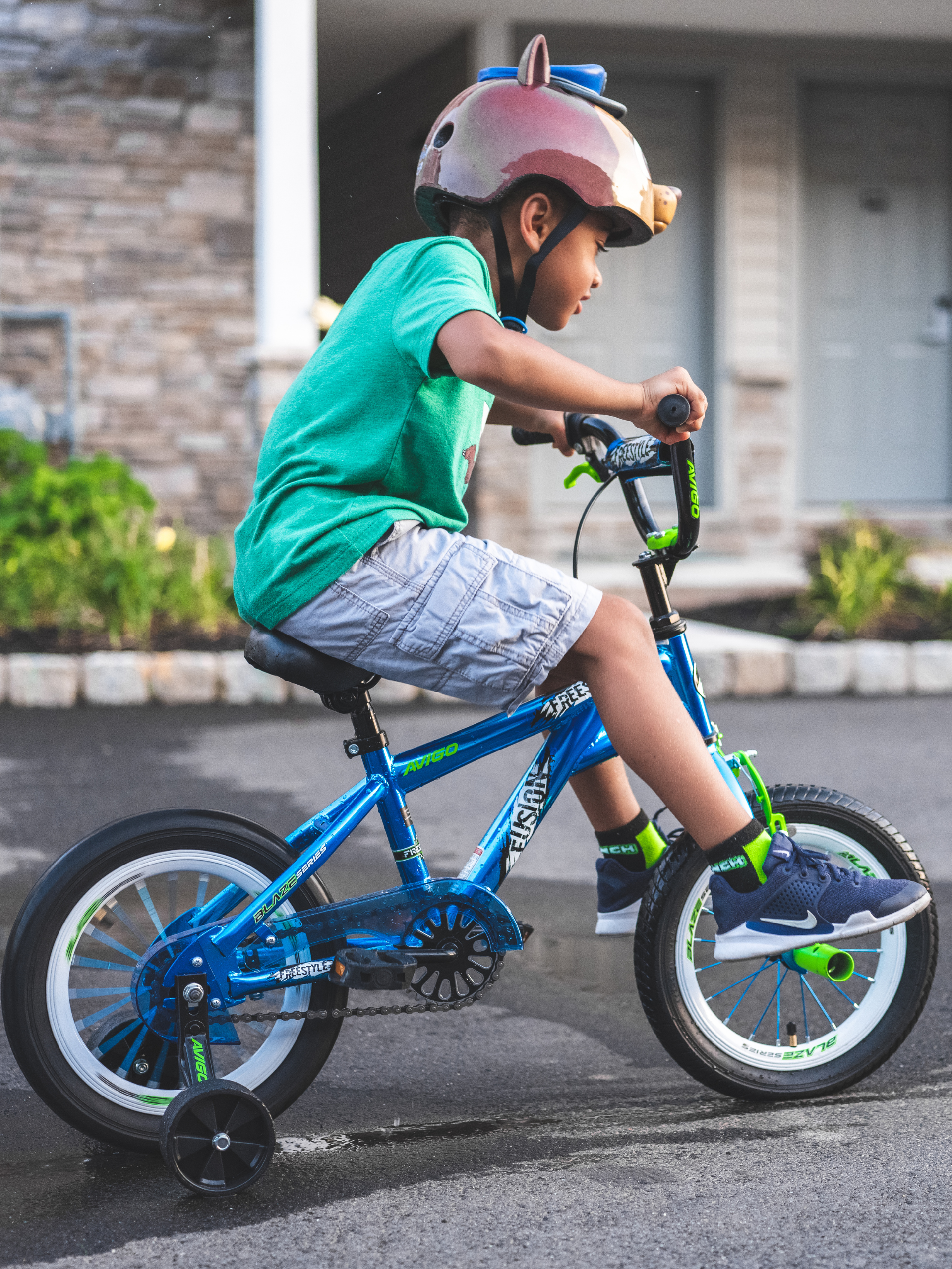 child on bicycle with training wheels