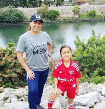 Maribel Hernandez, accounts payable finance clerk at CHOC and self-described “soccer mom,” poses with her daughter in a soccer uniform