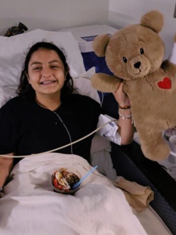 Oncology patient holds stuffed bear