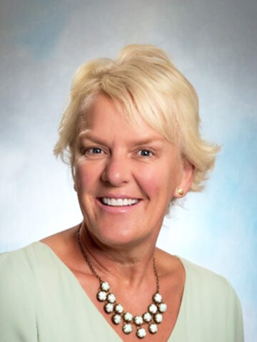 Blond woman wearing seafoam green blouse and beaded necklace - Headshot of Dr. Terrie Inder, Neonatologist at CHOC