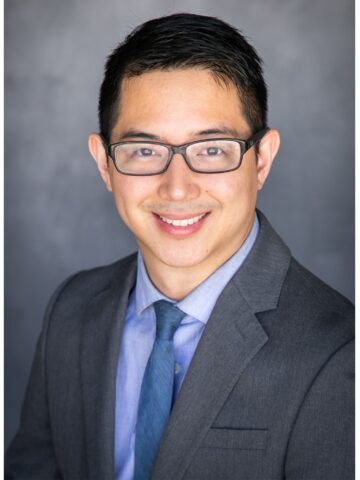 Male psychologist with dark hair, glasses and tie - Headshot Dr. Alexander Tan