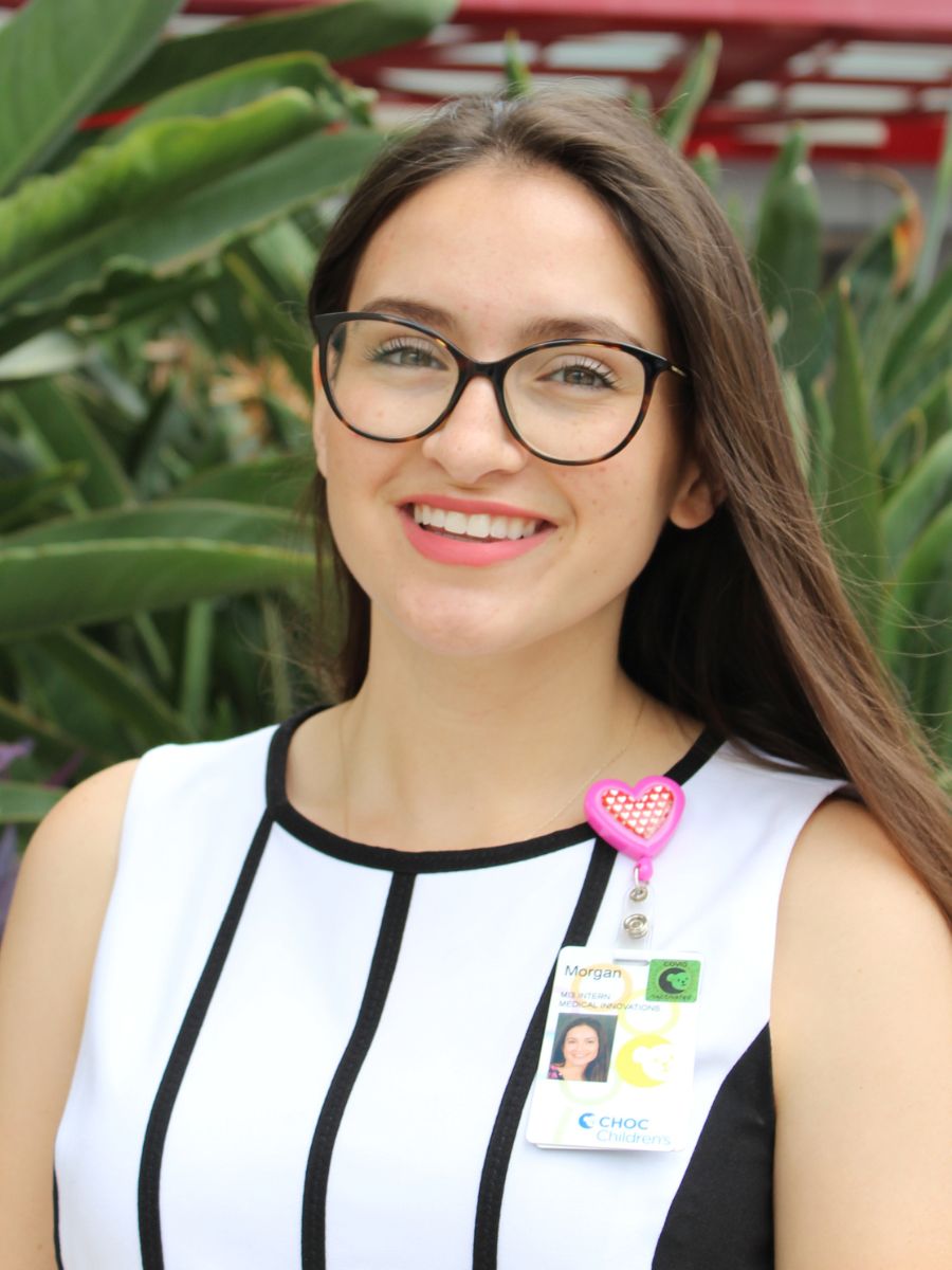 Woman with dark hair and glasses smiles at the camera - CHOC Intern Morgan