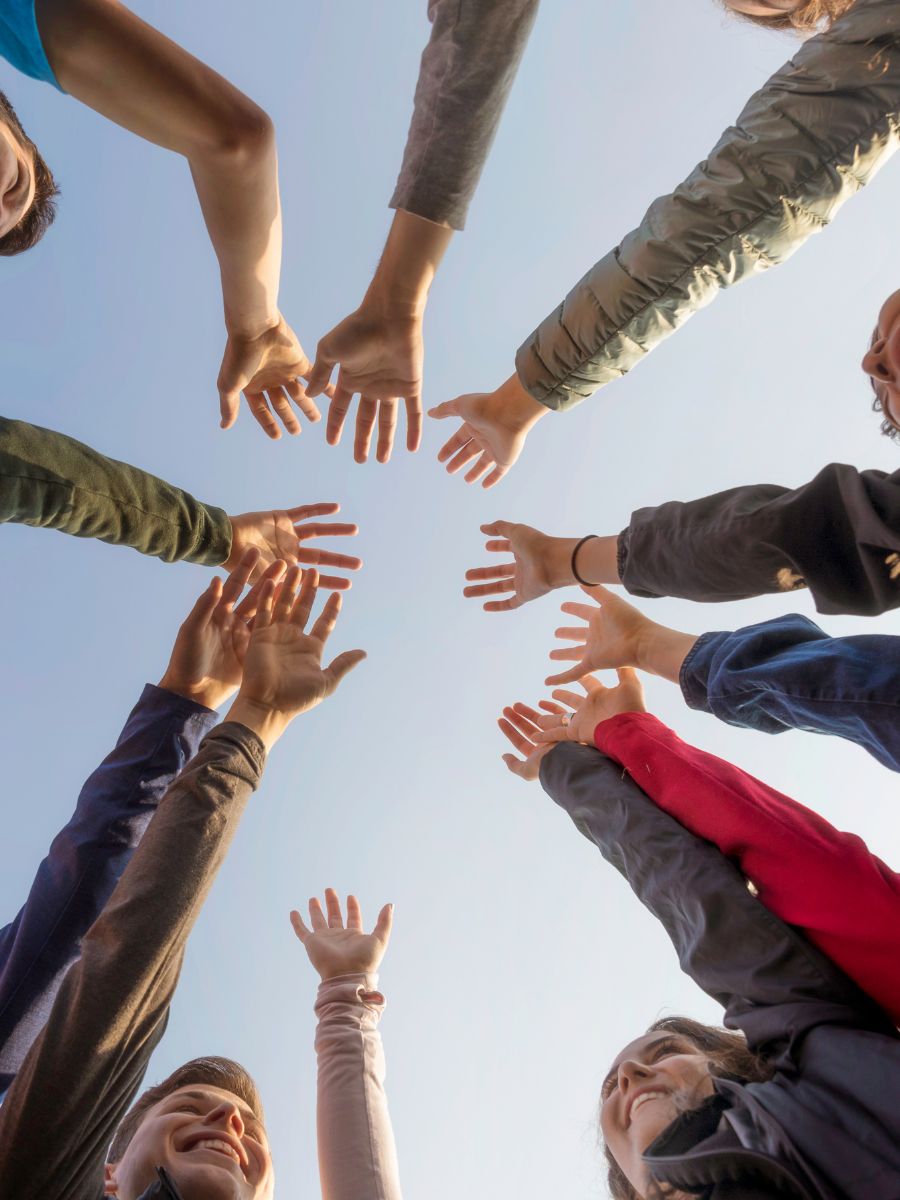 People raising hands in air - CHOC receives a 2023 Outstanding Care Center Partnership Award from the Cystic Fibrosis Foundation