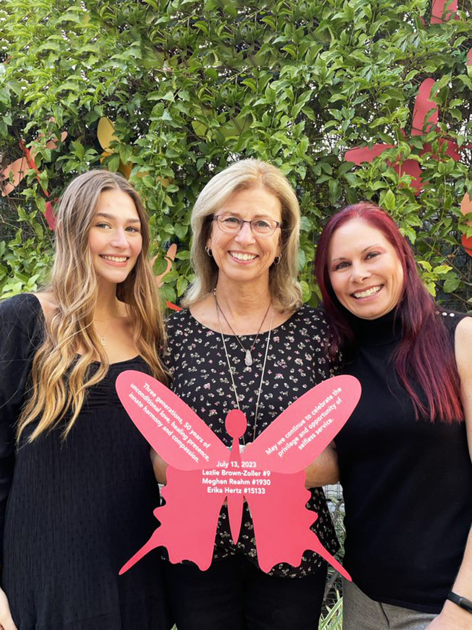 Erika, Lezlie and Meghen pose together with butterfly in CHOC's outdoor patio - three generations of CHOC nurses