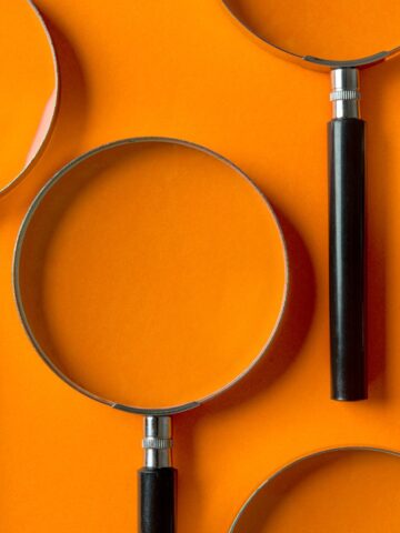 magnifying glasses against an orange background