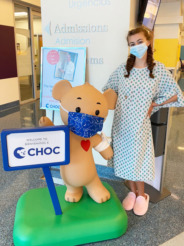 Sarah poses with Choco bear statue prior to her scoliosis surgery at CHOC Hospital in Orange 