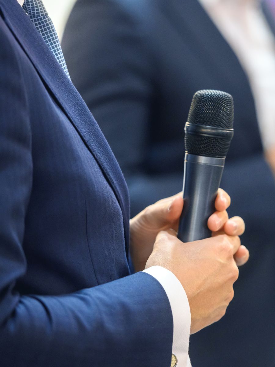 closeup of hands holding a microphone