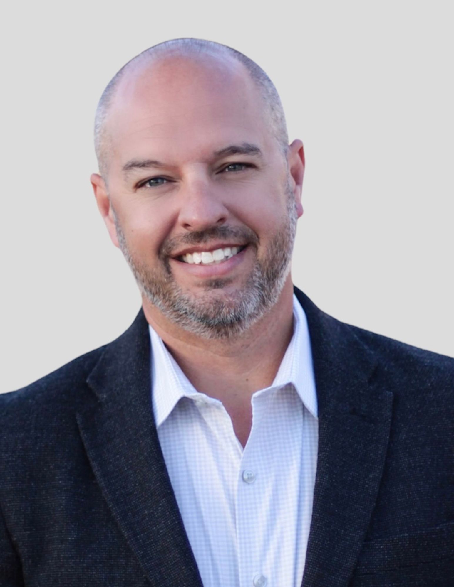 Smiling man wearing black blazer and white shirt