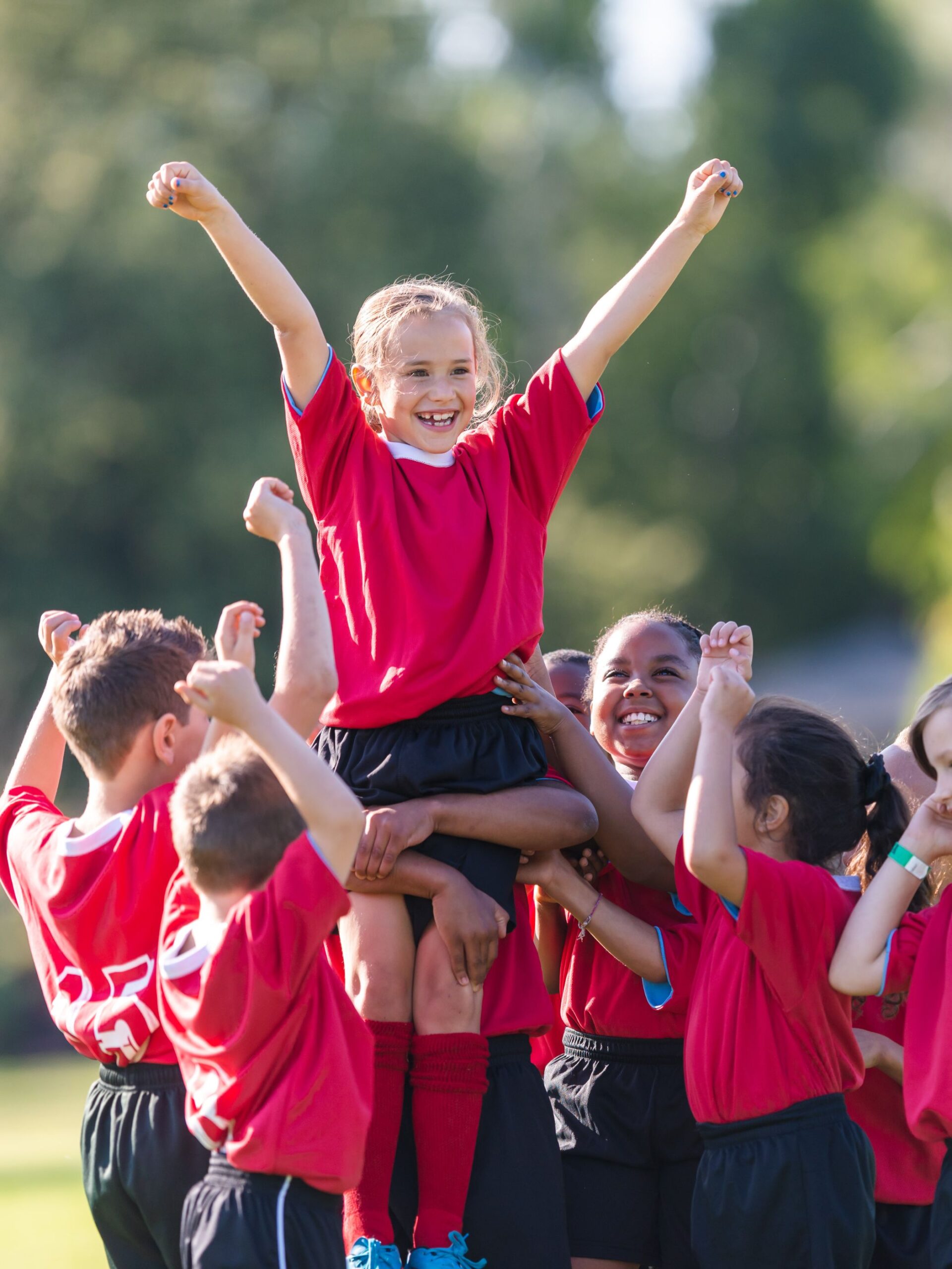 group of youth athletes celebrating a win