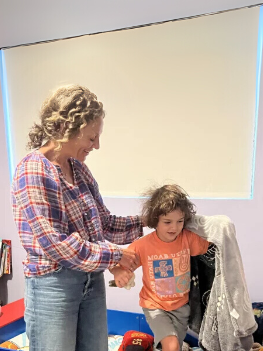 Caretaker getting their child ready for school