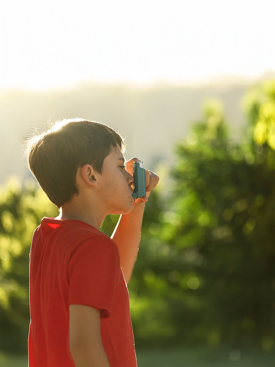 Child with inhaler on the street to avoid asthma related symptoms