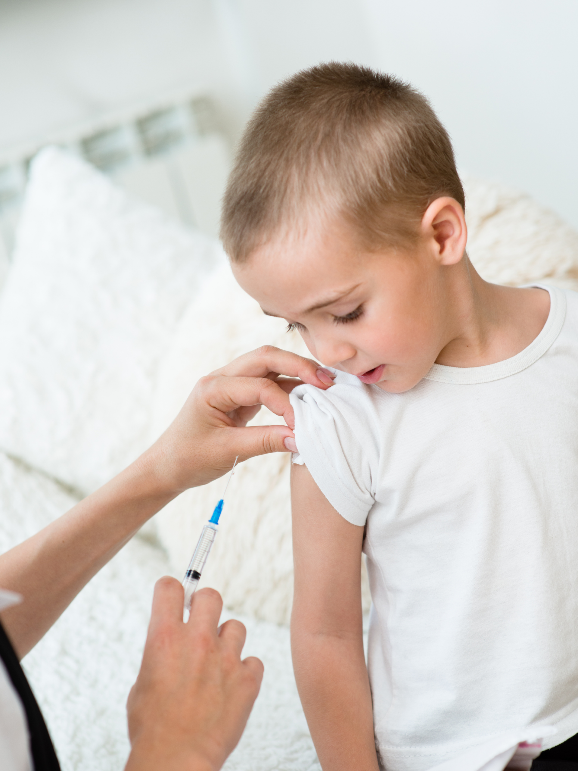 little boy receiving injection or vaccine