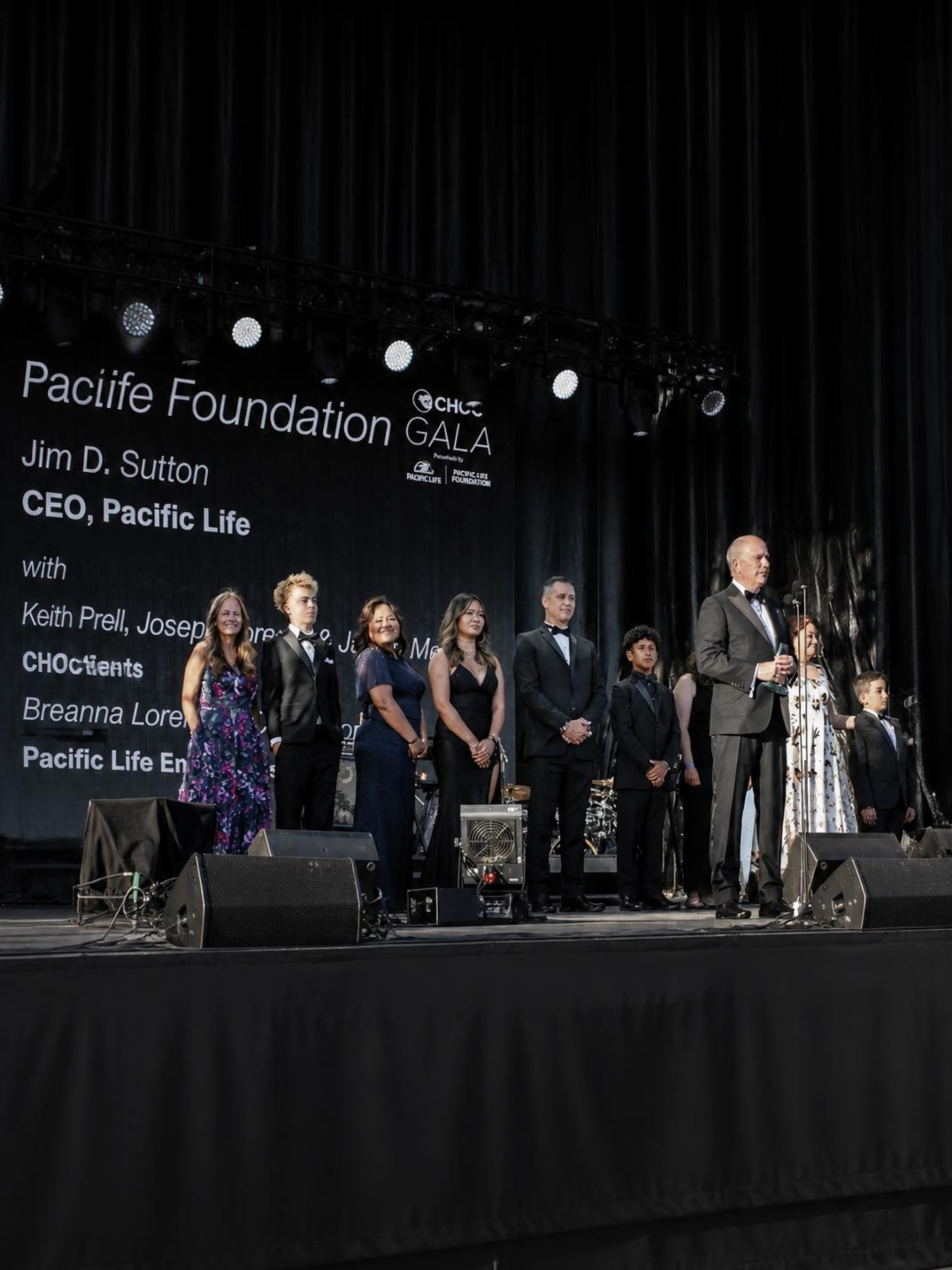 Group of adults and children on an event stage
